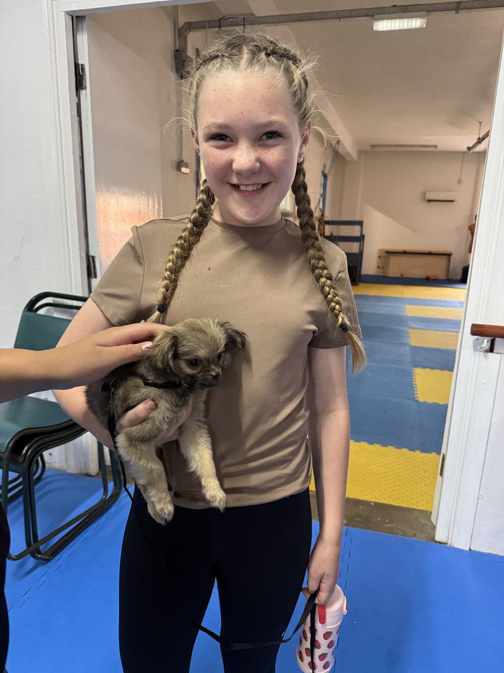 A gymnast holding a puppy